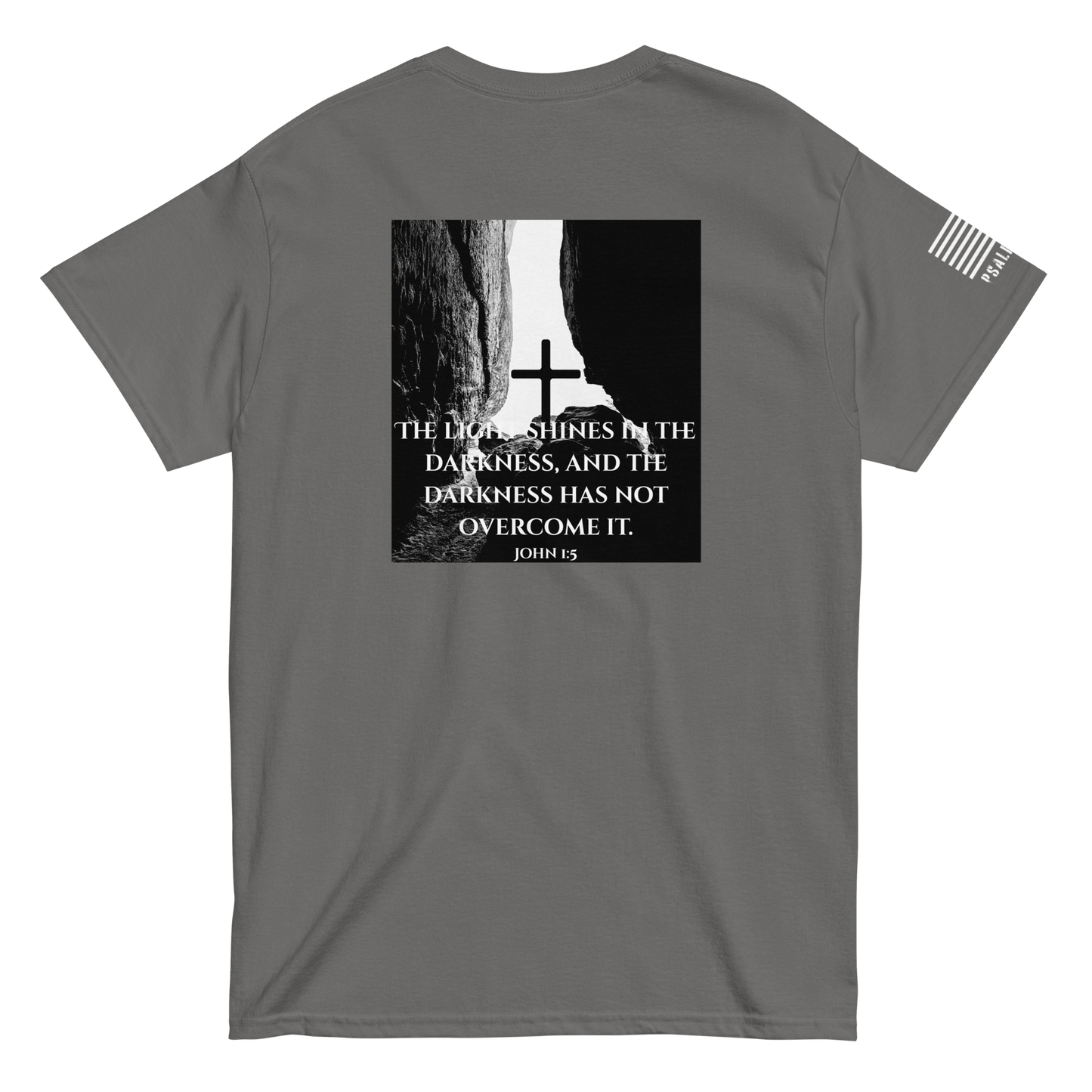 Faith-based tee from FFO’s Narrow Path Collection — features cross illuminated by light breaking through cave darkness, symbolizing John 1:5