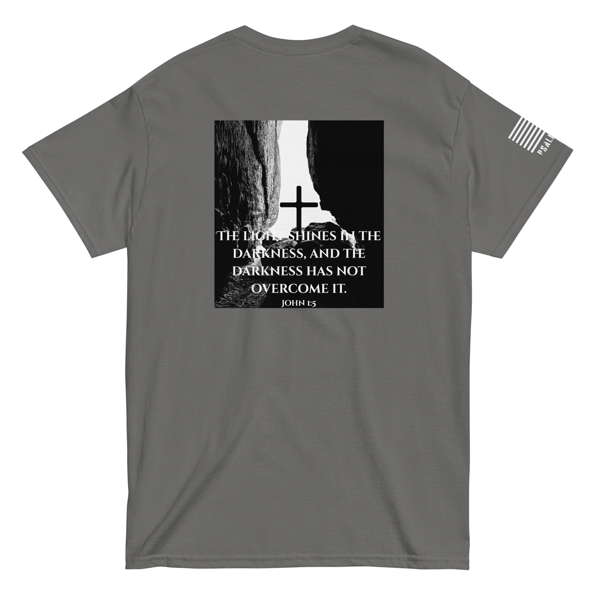 Faith-based tee from FFO’s Narrow Path Collection — features cross illuminated by light breaking through cave darkness, symbolizing John 1:5